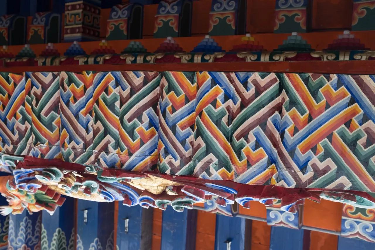 Fancy swastikas painted on the roof of a building in the monastery - Tongren, China